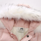 An adorable baby staying warm in a thick baby winter snowsuit with mittens.