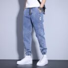 Stylish young man wearing comfortable mens denim jogger pants.