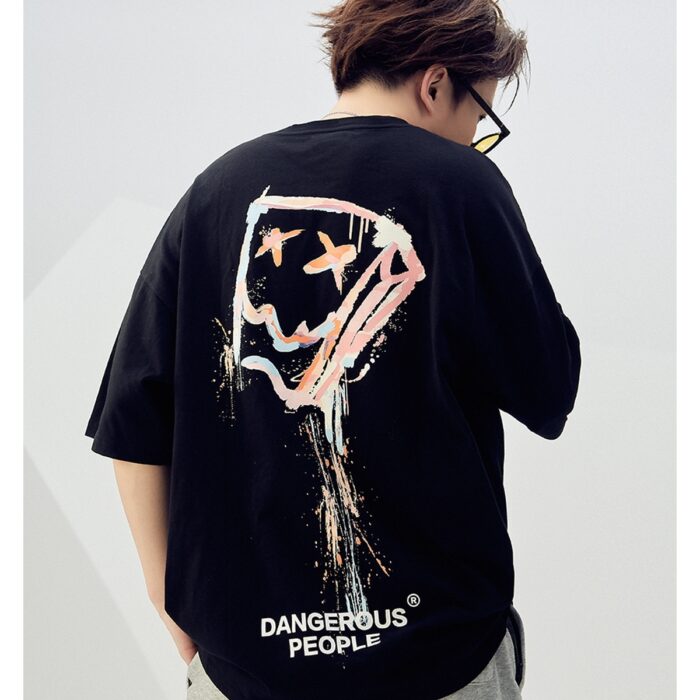 72decc47-b296-47d2-9144-563fc48ff74a.jpg A stylish man wearing a trendy mens oversized graphic t shirt with a paint splatter design.
