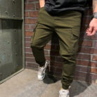Stylish young man wearing trendy mens casual cargo pants with utility pockets.