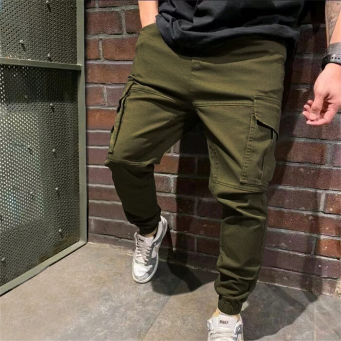 Stylish young man wearing trendy mens casual cargo pants with utility pockets.