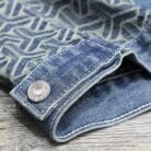 A stylish man wearing a trendy mens patchwork denim jacket for a casual streetwear look.
