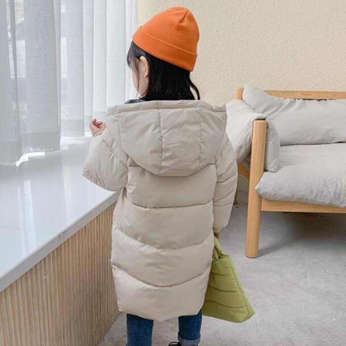 879575142901.jpg A happy child staying warm in the snow wearing a stylish kids thick winter coat.