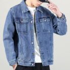 A stylish man wearing a versatile mens vintage distressed denim jacket for an edgy streetwear look.