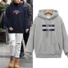 Stylish young woman wearing a trendy womens oversized letter print hoodie for everyday casual wear.
