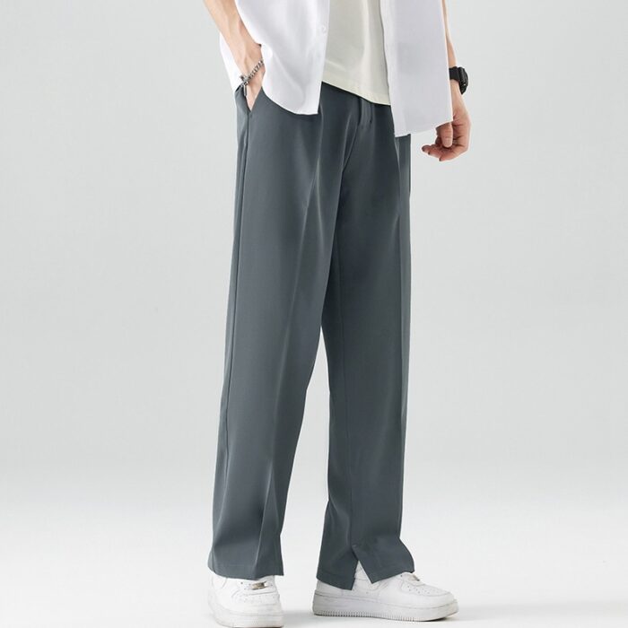 9051d9bc-31b0-4985-8e0a-456a611ee62e.jpg A stylish man wearing comfortable mens casual suit pants for a smart casual office look.