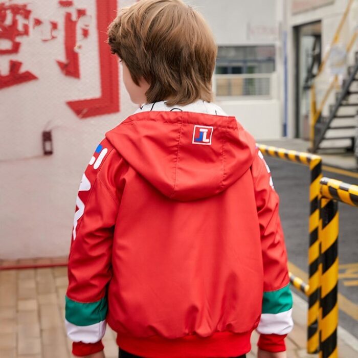 A young boy staying active outdoors wearing a vibrant boys hooded sports jacket.