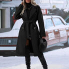 Close-up of the adjustable belt and classic lapel on a double breasted coat for women.