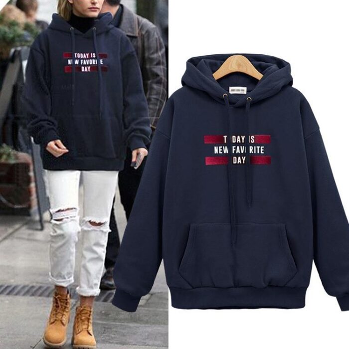 Stylish young woman wearing a trendy womens oversized letter print hoodie for everyday casual wear.
