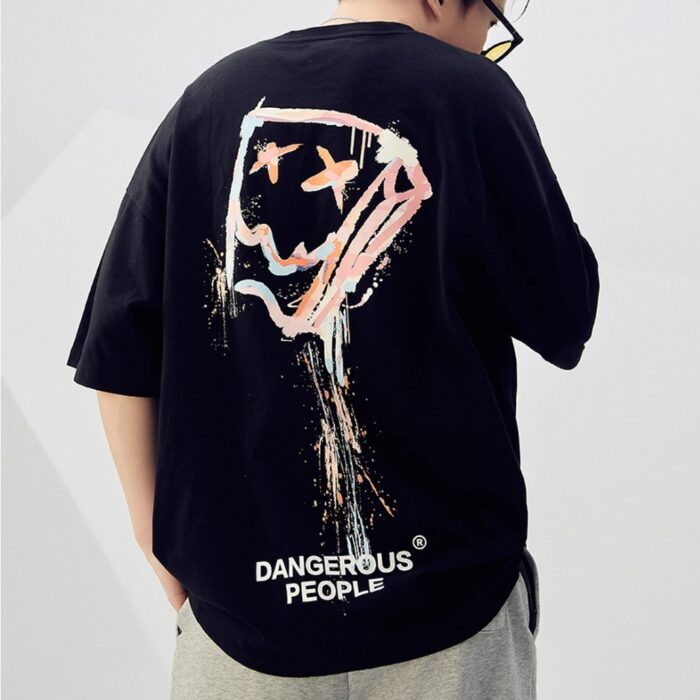9a7892ac-84d1-4600-b2f9-0b74ce0117f3.jpg A stylish man wearing a trendy mens oversized graphic t shirt with a paint splatter design.
