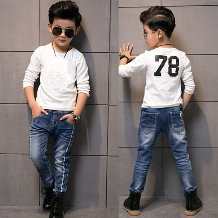 Close-up of the neat waistband and comfortable cotton fabric on kids casual denim pants.