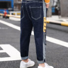 Close-up of the neat waistband and comfortable cotton fabric on kids casual denim pants.