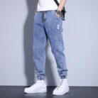 Stylish young man wearing comfortable mens denim jogger pants.