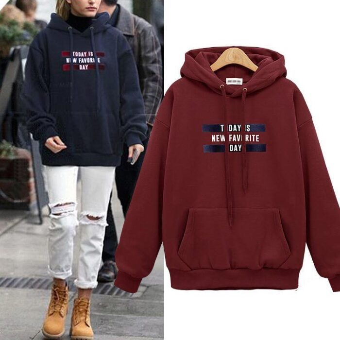 Stylish young woman wearing a trendy womens oversized letter print hoodie for everyday casual wear.