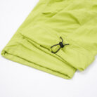 Close-up of the water-repellent nylon fabric and elastic drawstring on waterproof outdoor pants for kids.