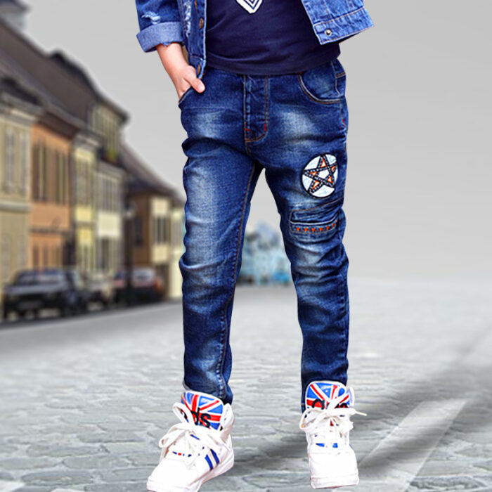 Close-up of the neat waistband and comfortable cotton fabric on kids casual denim pants.
