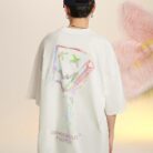 A stylish man wearing a trendy mens oversized graphic t shirt with a paint splatter design.