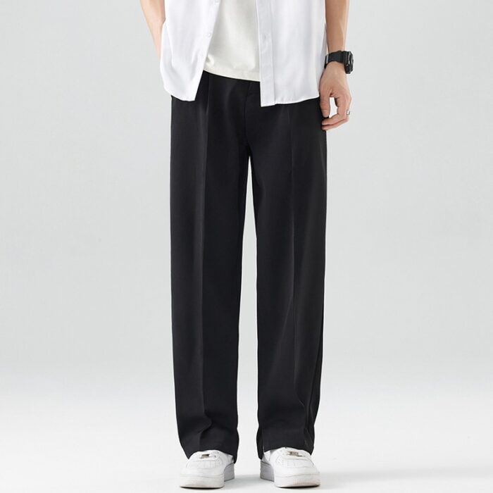 b2969e3f-8395-442e-8010-daa9867270d7.jpg A stylish man wearing comfortable mens casual suit pants for a smart casual office look.