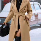 Close-up of the adjustable belt and classic lapel on a double breasted coat for women.