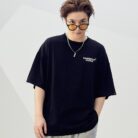 A stylish man wearing a trendy mens oversized graphic t shirt with a paint splatter design.