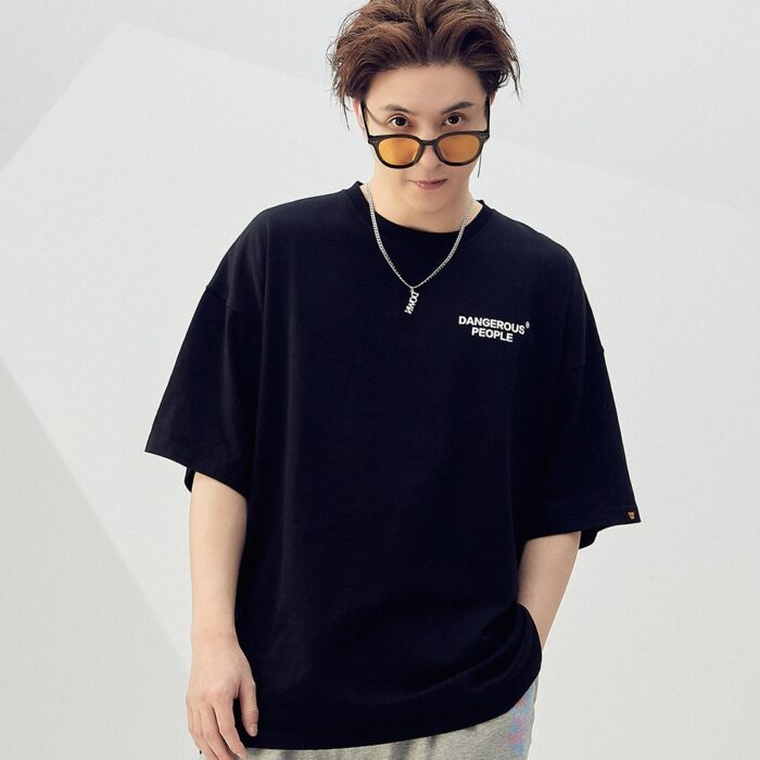 b3cdbe8d-d9ba-4605-b515-b45ccb582cb4.jpg A stylish man wearing a trendy mens oversized graphic t shirt with a paint splatter design.