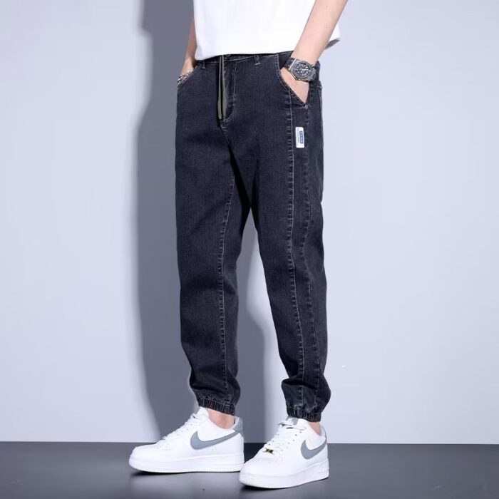 b5ae011e-d005-4fbe-b179-ca1a791765c4.jpg Stylish young man wearing comfortable mens denim jogger pants.