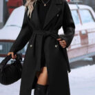 Close-up of the adjustable belt and classic lapel on a double breasted coat for women.
