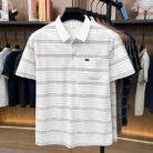 A stylish man wearing a comfortable mens striped polo shirt for a smart casual weekend look.