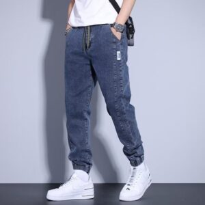 d0443783-45ea-4bea-8d59-ebae7e8ac5f7.jpg Stylish young man wearing comfortable mens denim jogger pants.