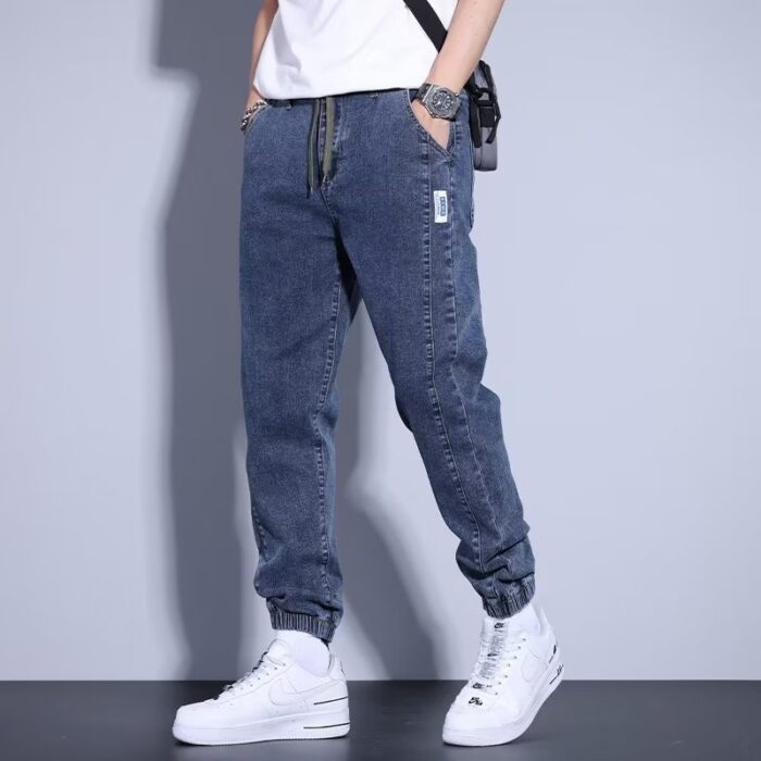 d0443783-45ea-4bea-8d59-ebae7e8ac5f7.jpg Stylish young man wearing comfortable mens denim jogger pants.