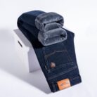 Handsome young man wearing comfortable mens straight leg jeans.