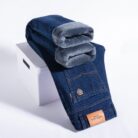 Handsome young man wearing comfortable mens straight leg jeans.