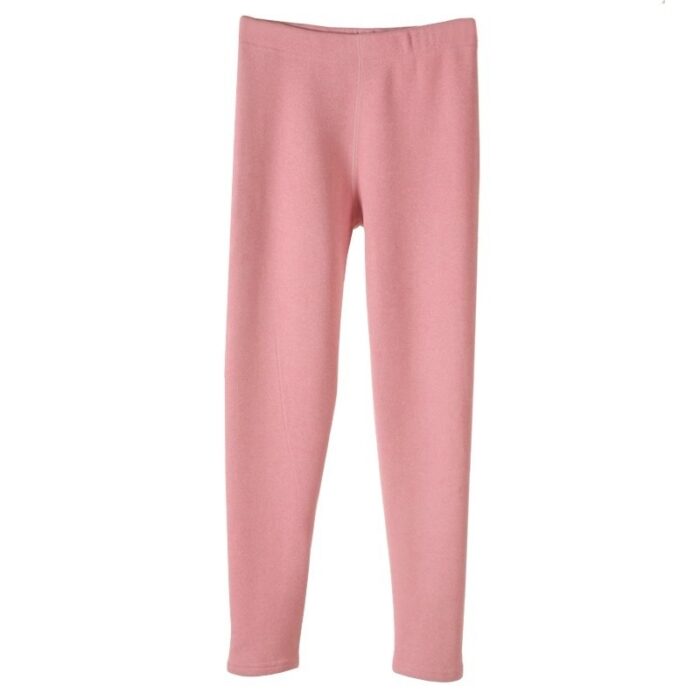 Stylish woman staying warm in thick womens thermal winter leggings for travel.