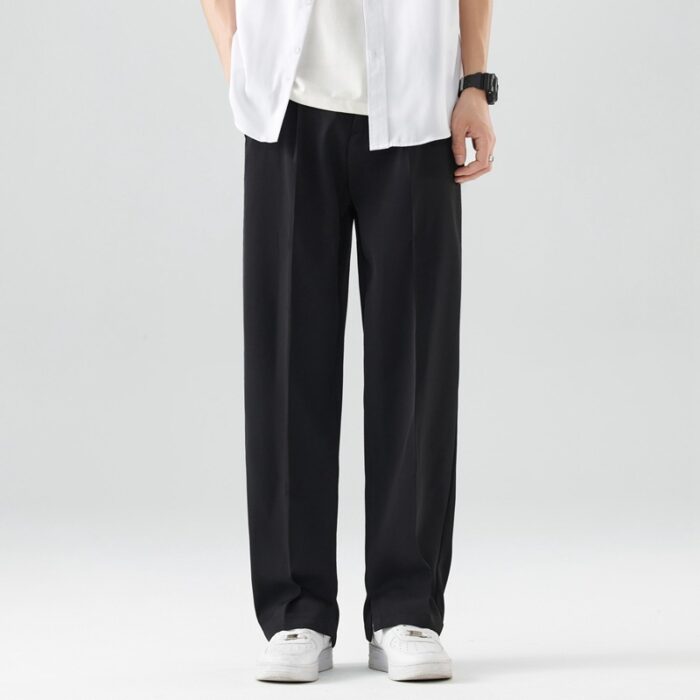 f78501af-a771-4ef0-81a4-597971ba42e9.jpg A stylish man wearing comfortable mens casual suit pants for a smart casual office look.