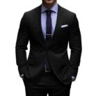 Handsome young man wearing a stylish mens slim fit two piece suit.