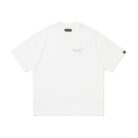 A stylish man wearing a trendy mens oversized graphic t shirt with a paint splatter design.