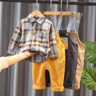 A handsome little boy ready for a special occasion wearing a toddler boy formal suspender outfit from K&K Trend Wear.