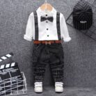 A handsome little boy ready for a special occasion wearing a toddler boy formal suspender outfit from K&K Trend Wear.