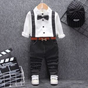 A handsome little boy ready for a special occasion wearing a toddler boy formal suspender outfit from K&K Trend Wear.