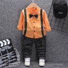 A handsome little boy ready for a special occasion wearing a toddler boy formal suspender outfit from K&K Trend Wear.