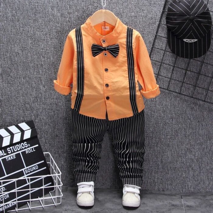 1621910354301.jpg A handsome little boy ready for a special occasion wearing a toddler boy formal suspender outfit from K&K Trend Wear.