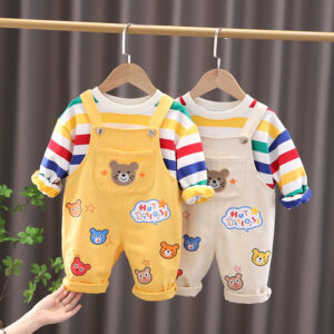 An adorable little boy ready for a party wearing a toddler boy overalls and shirt set from K&K trend Wear.