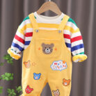 An adorable little boy ready for a party wearing a toddler boy overalls and shirt set from K&K trend Wear.