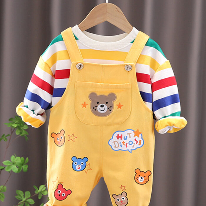 An adorable little boy ready for a party wearing a toddler boy overalls and shirt set from K&K trend Wear.