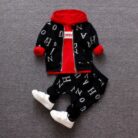 A happy child wearing a comfortable kids 2 piece long sleeve outfit for everyday play from K&K Trend Wear.
