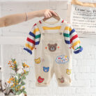 An adorable little boy ready for a party wearing a toddler boy overalls and shirt set from K&K trend Wear.