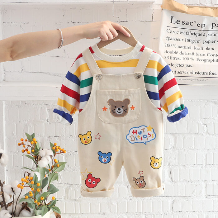 An adorable little boy ready for a party wearing a toddler boy overalls and shirt set from K&K trend Wear.