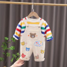 An adorable little boy ready for a party wearing a toddler boy overalls and shirt set from K&K trend Wear.