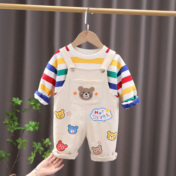 An adorable little boy ready for a party wearing a toddler boy overalls and shirt set from K&K trend Wear.