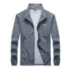 A man outdoors wearing a versatile mens uv protection fishing jacket for summer sun protection from K&K Trend Wear.